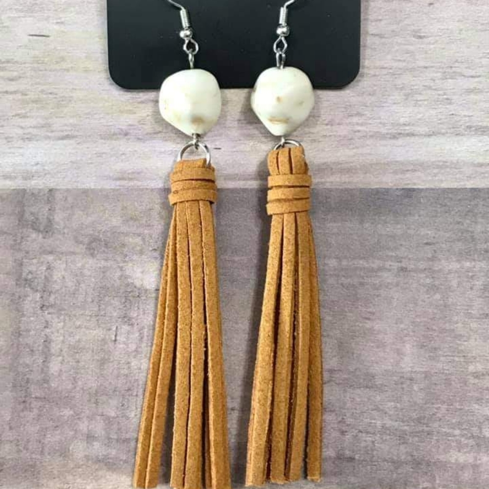 Tan suede fringe earrings.